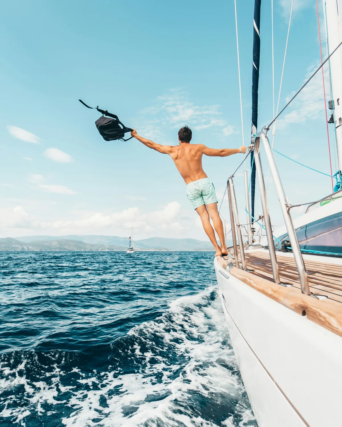 Traveler jumping into the ocean on a tour