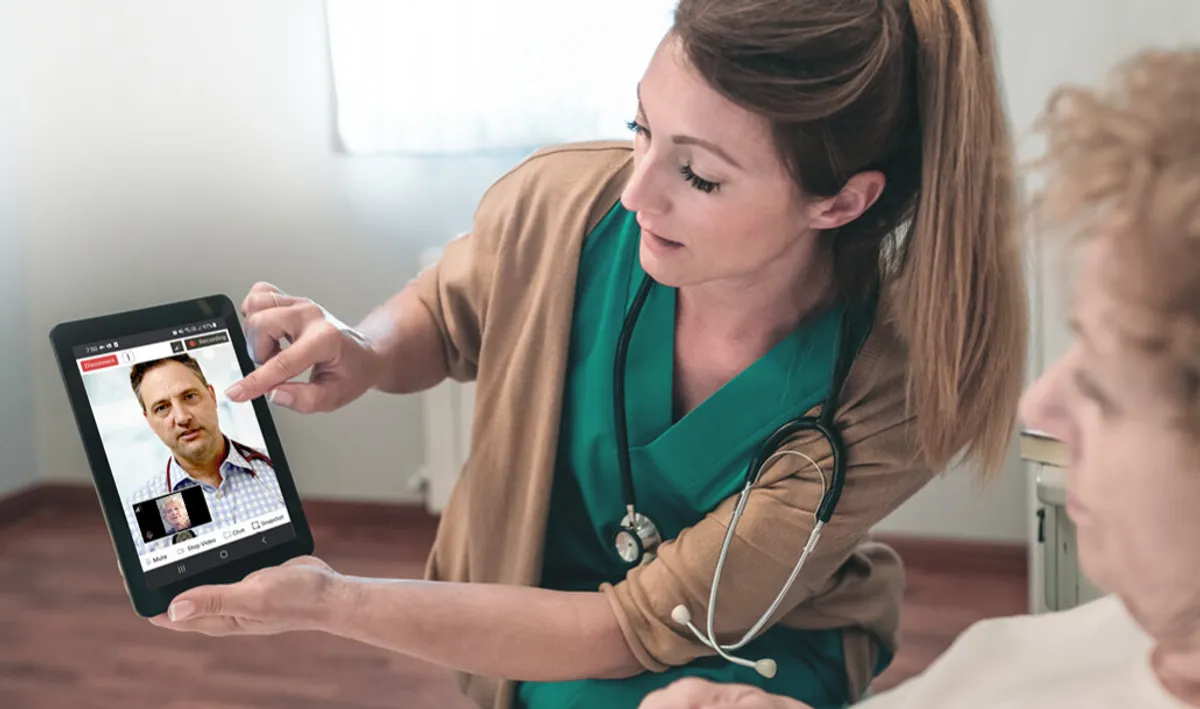 Healthcare professional using tablet for remote care