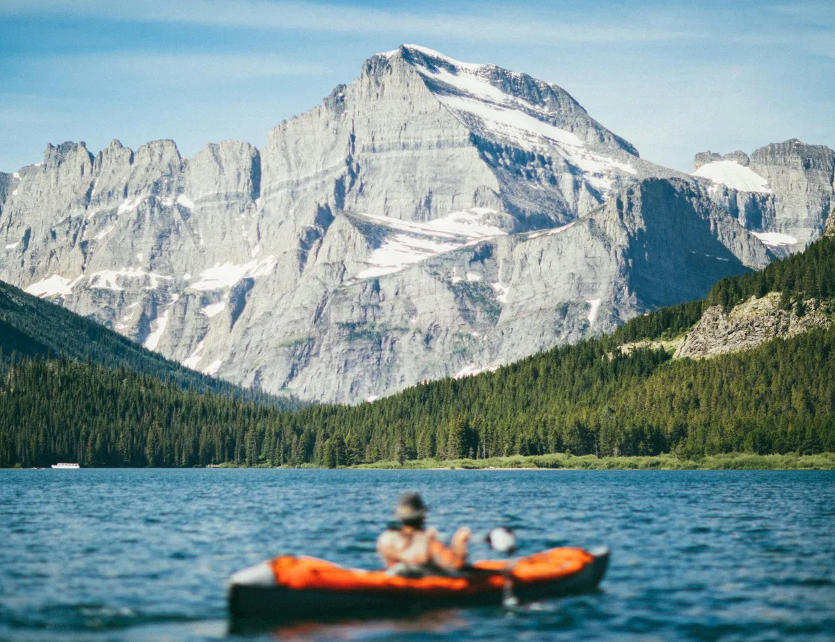 Traveler kayaking on a scenic lake